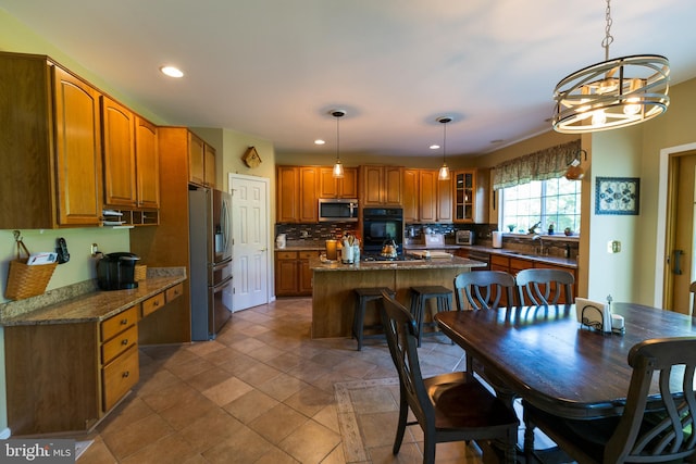 294 Arthur Ave, Port Deposit, MD 21904 - kitchen with stainless steel appliances, brown cabinets, recessed lighting, a center island, and tasteful backsplash