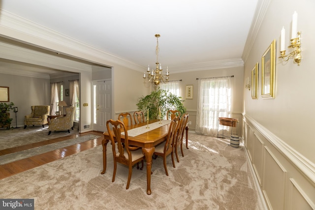 294 Arthur Ave, Port Deposit, MD 21904 - dining area with a decorative wall, a chandelier, ornamental molding, wainscoting, and light wood-type flooring