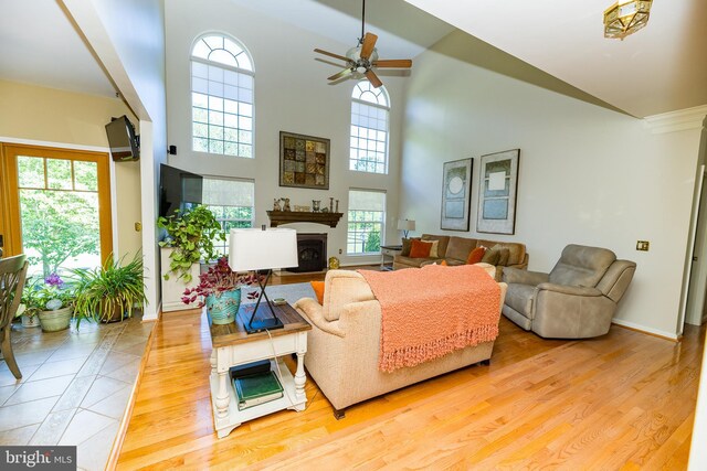 294 Arthur Ave, Port Deposit, MD 21904 - living room featuring a fireplace with flush hearth, a ceiling fan, baseboards, a high ceiling, and wood finished floors
