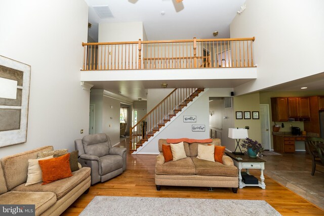 294 Arthur Ave, Port Deposit, MD 21904 - living area featuring a towering ceiling, a ceiling fan, stairway, and light wood-style floors