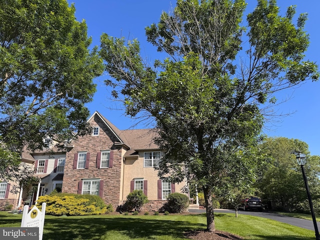 318 Ironstone Ln, Elverson, PA 19520 - view of front of home featuring stone siding and a front lawn
