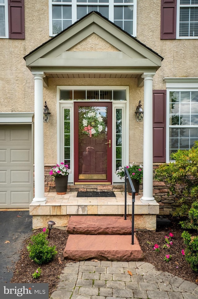 318 Ironstone Ln, Elverson, PA 19520 - property entrance featuring stucco siding, a garage, and driveway