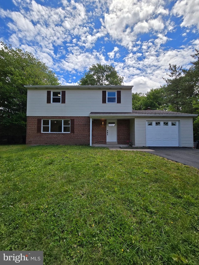 585 Andrew Dr, Southampton, PA 18966 - traditional-style home with asphalt driveway, brick siding, a front yard, and an attached garage