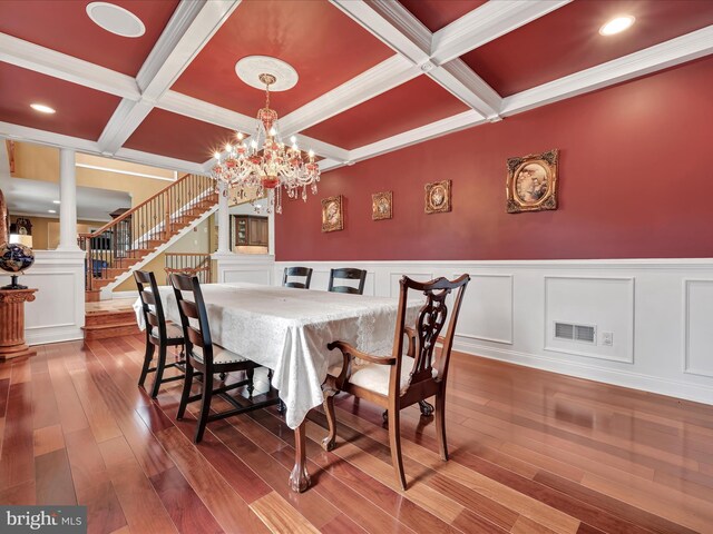 dining space with coffered ceiling, decorative columns, beamed ceiling, stairs, and hardwood / wood-style flooring