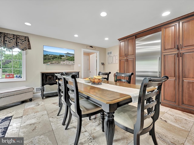 dining area with recessed lighting, stone tile floors, and baseboards