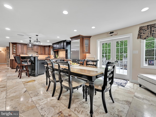 dining area with recessed lighting, baseboards, and stone tile flooring