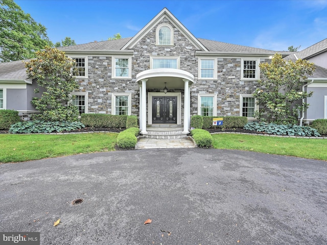 view of front of house featuring french doors and stone siding