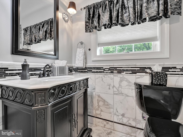 bathroom with marble look tiles, vanity, and decorative backsplash