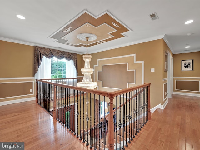 hall featuring light wood-style flooring, crown molding, recessed lighting, baseboards, and an upstairs landing
