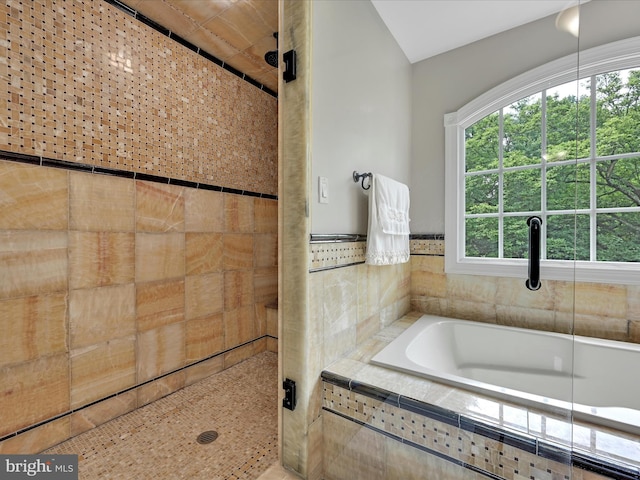 full bath featuring a stall shower and a garden tub