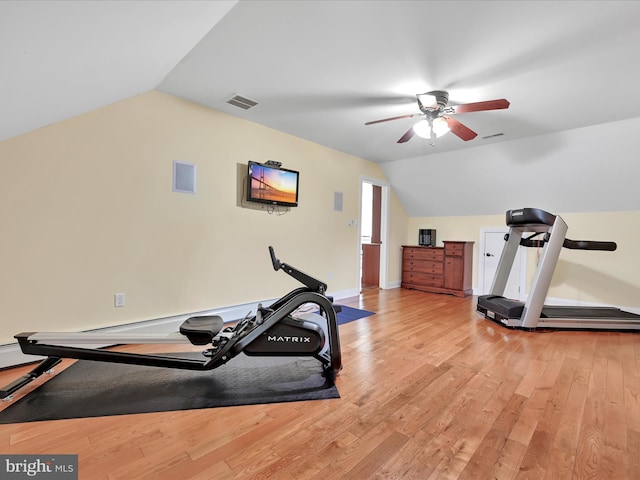 exercise area featuring lofted ceiling, a ceiling fan, light wood-type flooring, and baseboards