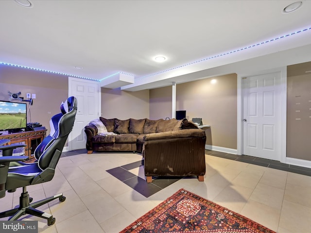 tiled living room with baseboards and an office area