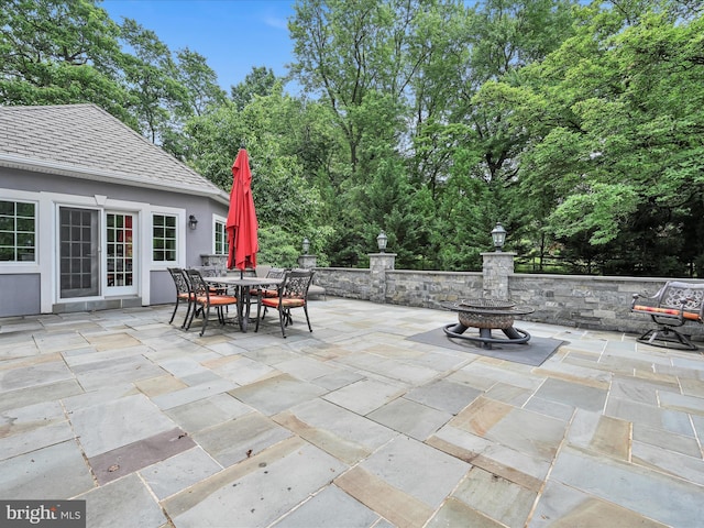 view of patio / terrace featuring outdoor dining area and an outdoor fire pit