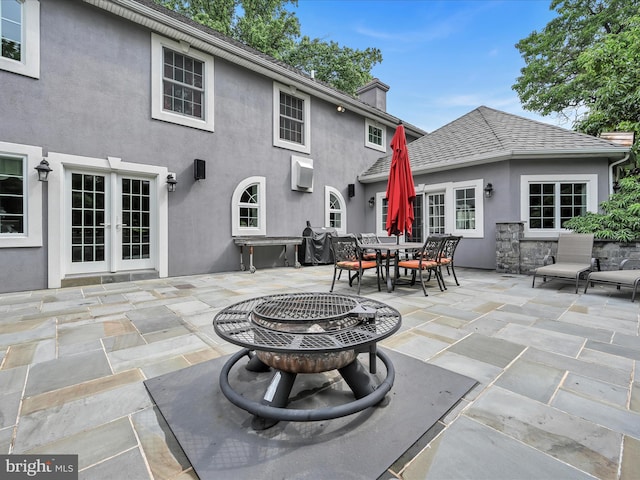 view of patio featuring french doors, outdoor dining area, and grilling area