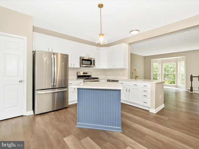 5534 Upshur, Frederick, MD 21703 - kitchen featuring stainless steel appliances, light countertops, wood finished floors, and white cabinets