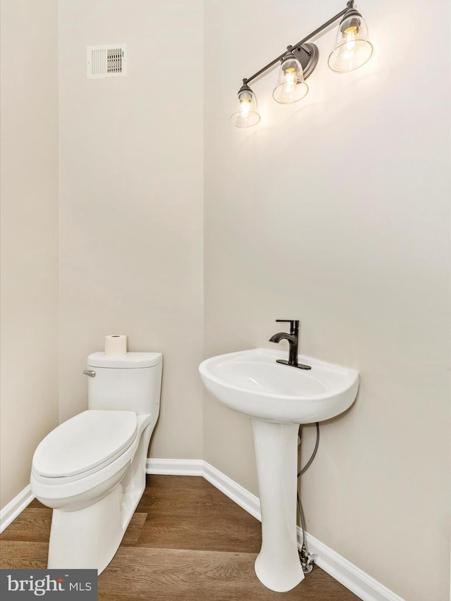 5534 Upshur, Frederick, MD 21703 - half bath featuring wood finished floors, toilet, and baseboards