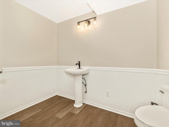 5534 Upshur, Frederick, MD 21703 - bathroom with wood finished floors, wainscoting, toilet, baseboards, and a sink