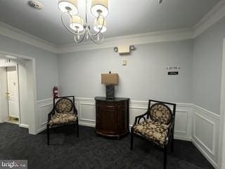 2607 Chapel Lake Dr Unit 108, Gambrills, MD 21054 - living area with crown molding, a chandelier, a wainscoted wall, and a decorative wall