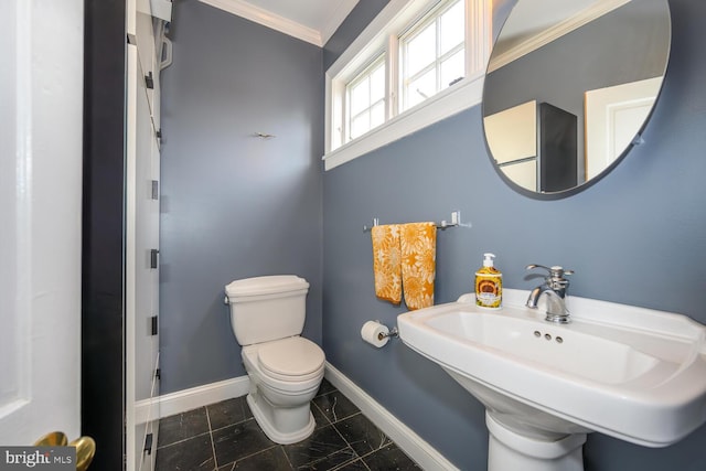 213 N Queen St, Chestertown, MD 21620 - bathroom featuring baseboards, crown molding, toilet, and a sink