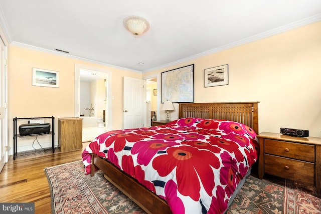 213 N Queen St, Chestertown, MD 21620 - bedroom featuring ornamental molding, wood finished floors, ensuite bathroom, and baseboards