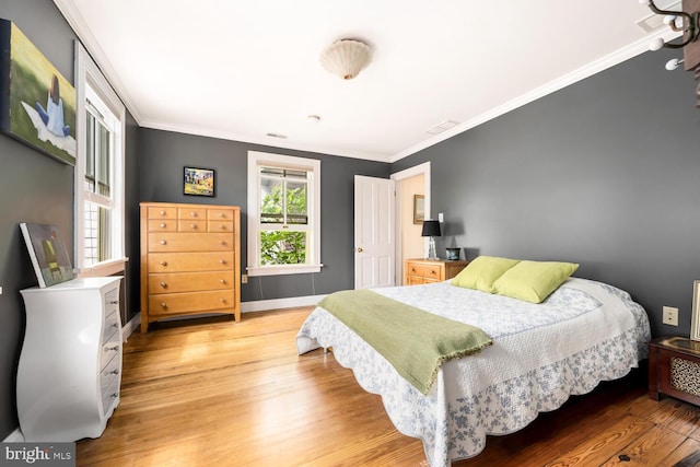 213 N Queen St, Chestertown, MD 21620 - bedroom with light wood-style floors, ornamental molding, and baseboards