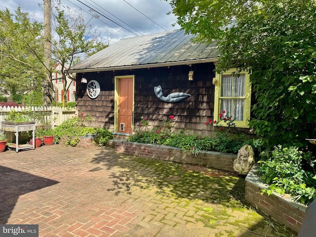 213 N Queen St, Chestertown, MD 21620 - view of front facade featuring metal roof and a patio