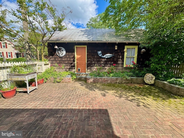 213 N Queen St, Chestertown, MD 21620 - view of front facade featuring a patio area and metal roof