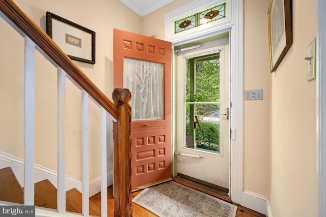 213 N Queen St, Chestertown, MD 21620 - entrance foyer featuring wood finished floors, stairway, baseboards, and crown molding