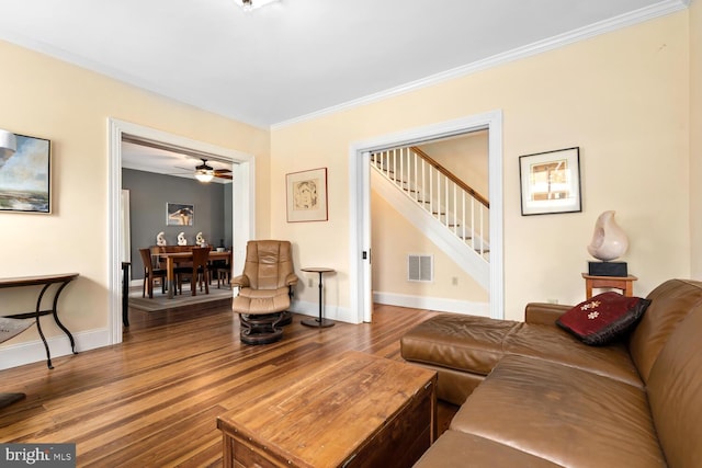 213 N Queen St, Chestertown, MD 21620 - living area featuring stairway, wood finished floors, crown molding, and baseboards