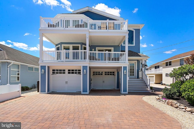 38 N 10th St, Surf City, NJ 08008 - raised beach house featuring a balcony, a garage, and decorative driveway