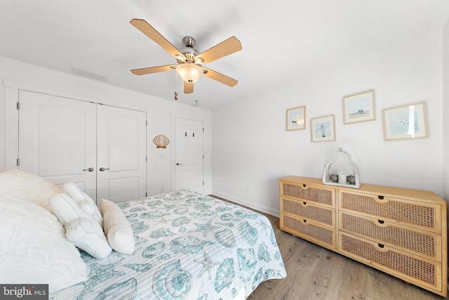38 N 10th St, Surf City, NJ 08008 - bedroom with wood finished floors, a closet, baseboards, and a ceiling fan