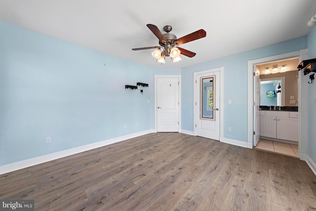 38 N 10th St, Surf City, NJ 08008 - unfurnished bedroom with wood finished floors, baseboards, ensuite bathroom, and a ceiling fan