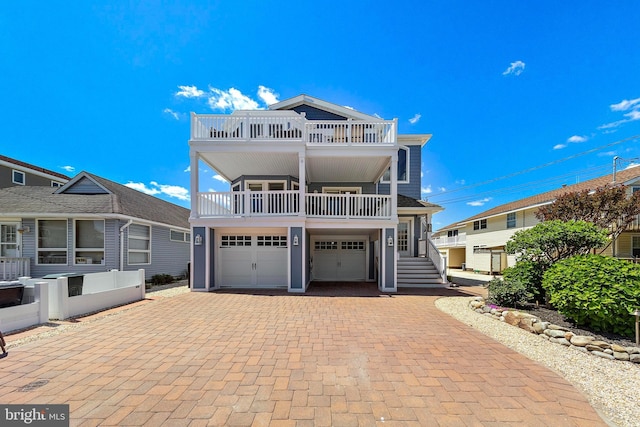 38 N 10th St, Surf City, NJ 08008 - coastal inspired home with a balcony, decorative driveway, and an attached garage
