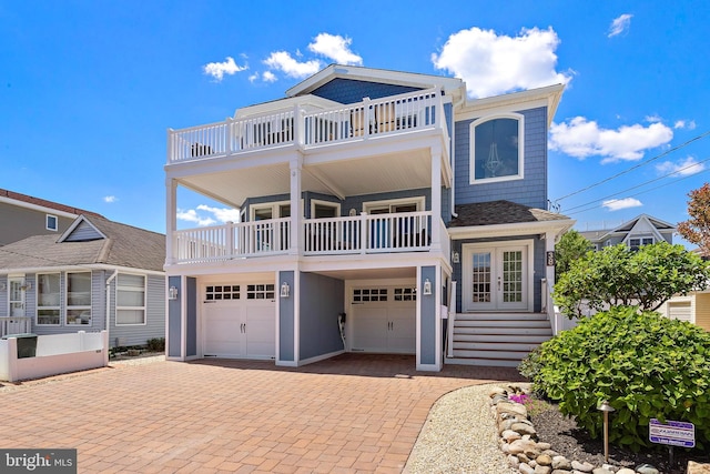 38 N 10th St, Surf City, NJ 08008 - view of front of property featuring a balcony, french doors, a garage, and decorative driveway