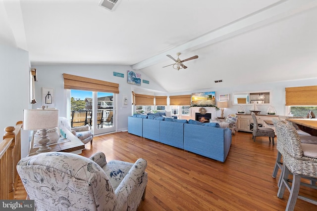 38 N 10th St, Surf City, NJ 08008 - living room featuring plenty of natural light, a ceiling fan, wood finished floors, and a warm lit fireplace