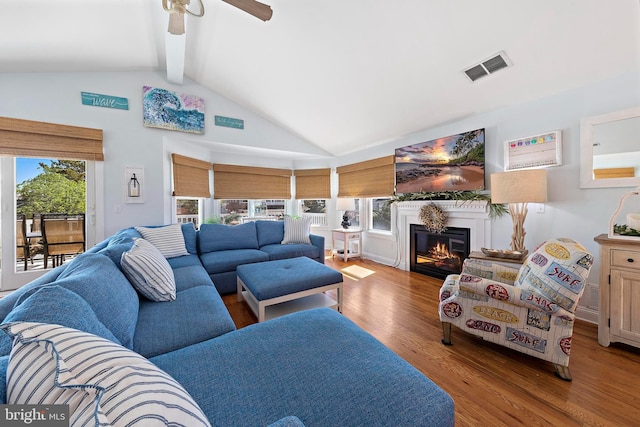 38 N 10th St, Surf City, NJ 08008 - living room with beamed ceiling, wood finished floors, a glass covered fireplace, a ceiling fan, and high vaulted ceiling