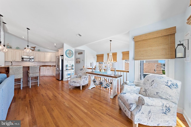 38 N 10th St, Surf City, NJ 08008 - living area featuring a chandelier, lofted ceiling, and light wood-style flooring