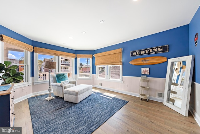 38 N 10th St, Surf City, NJ 08008 - living area featuring wainscoting, hardwood / wood-style floors, and healthy amount of natural light