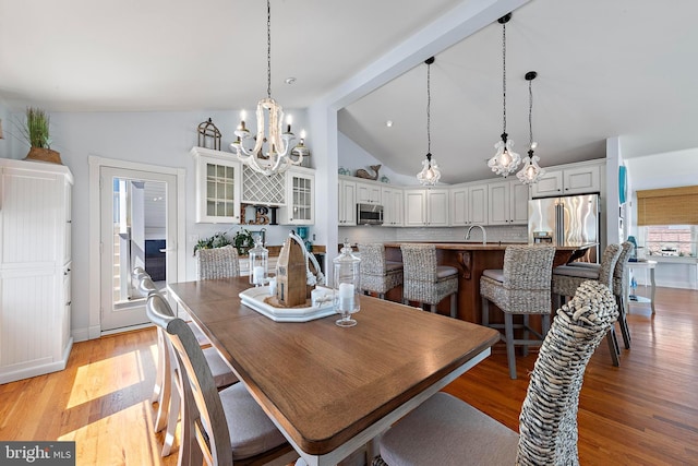 38 N 10th St, Surf City, NJ 08008 - dining area featuring a chandelier, light wood-style flooring, and baseboards