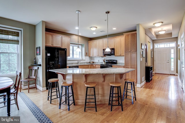 137 Settlers Way, Boalsburg, PA 16827 - kitchen featuring black appliances, light wood-style flooring, a kitchen bar, a center island, and recessed lighting