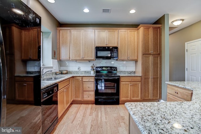 137 Settlers Way, Boalsburg, PA 16827 - kitchen featuring black appliances, light wood-style floors, light stone countertops, decorative backsplash, and recessed lighting