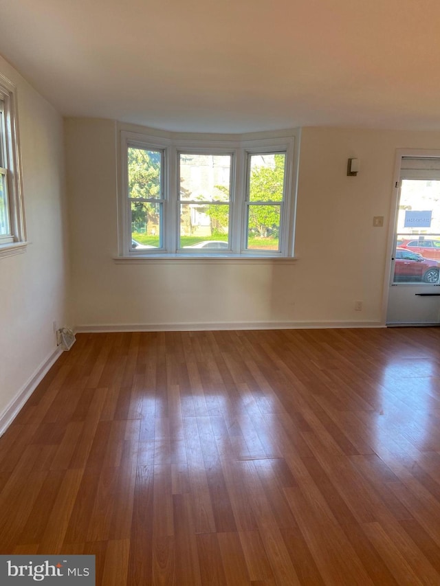 4014 Lansing St, Philadelphia, PA 19136 - empty room featuring plenty of natural light, wood finished floors, and baseboards