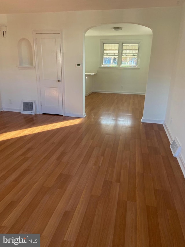 4014 Lansing St, Philadelphia, PA 19136 - unfurnished room featuring arched walkways, baseboards, and wood finished floors