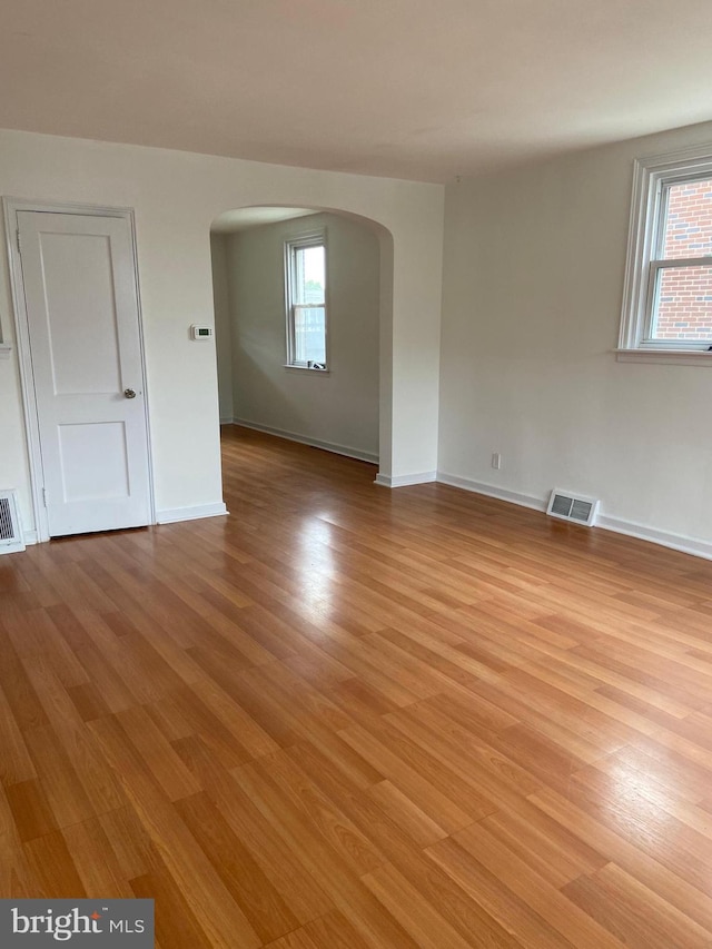 4014 Lansing St, Philadelphia, PA 19136 - unfurnished room featuring arched walkways, light wood-style flooring, plenty of natural light, and baseboards