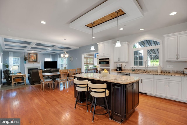 26248 Tranquility View Ct, Mechanicsville, MD 20659 - kitchen with stainless steel oven, a sink, light wood finished floors, white cabinets, and recessed lighting