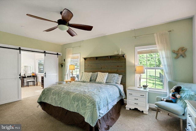 26248 Tranquility View Ct, Mechanicsville, MD 20659 - bedroom with light colored carpet, a barn door, and ceiling fan