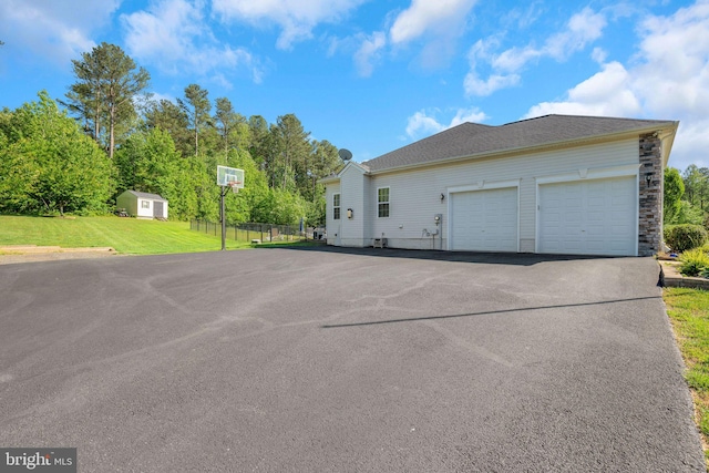 26248 Tranquility View Ct, Mechanicsville, MD 20659 - view of side of home featuring asphalt driveway and a garage