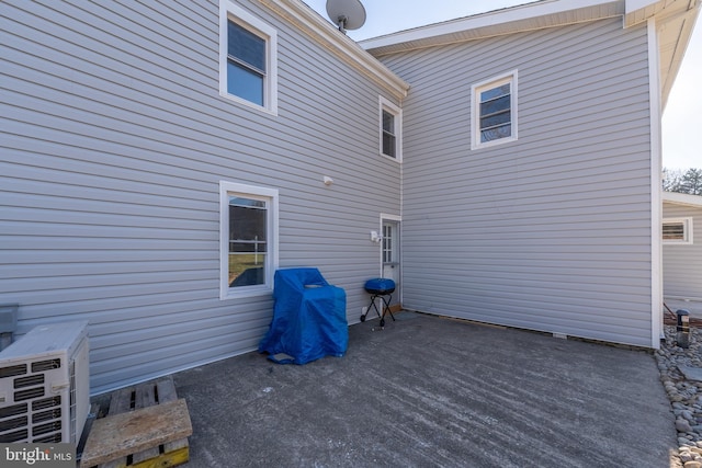 rear view of house with a patio area and ac unit