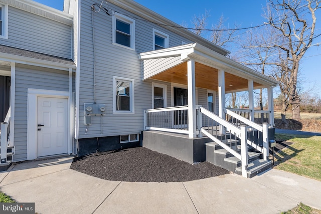 view of exterior entry with covered porch