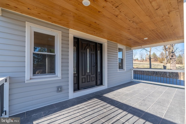 view of exterior entry with covered porch